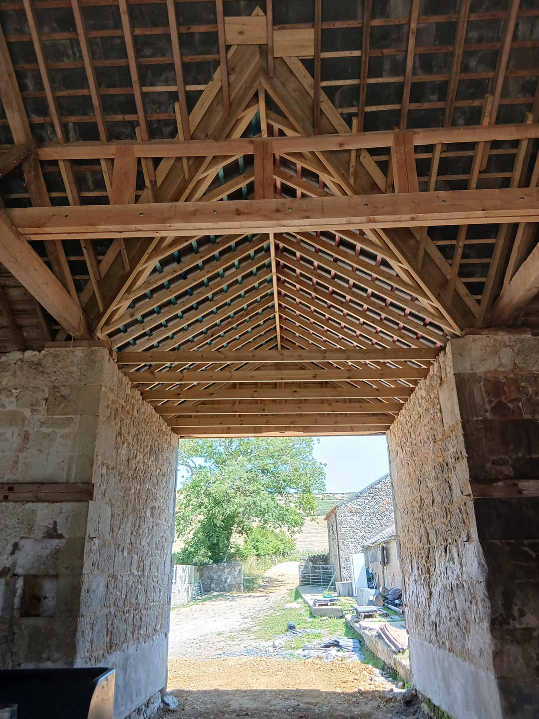 Interior of newly restored stone barn roof with timber frames