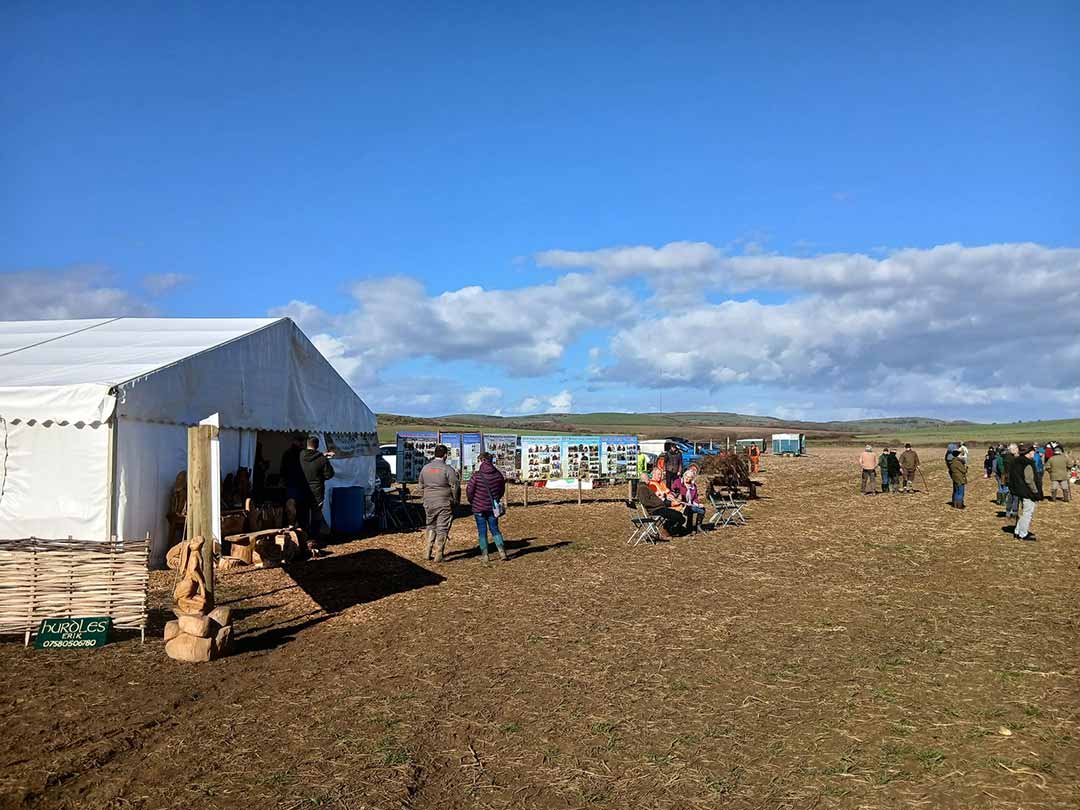 Photo of traditional hedgelaying competition with people in the distance